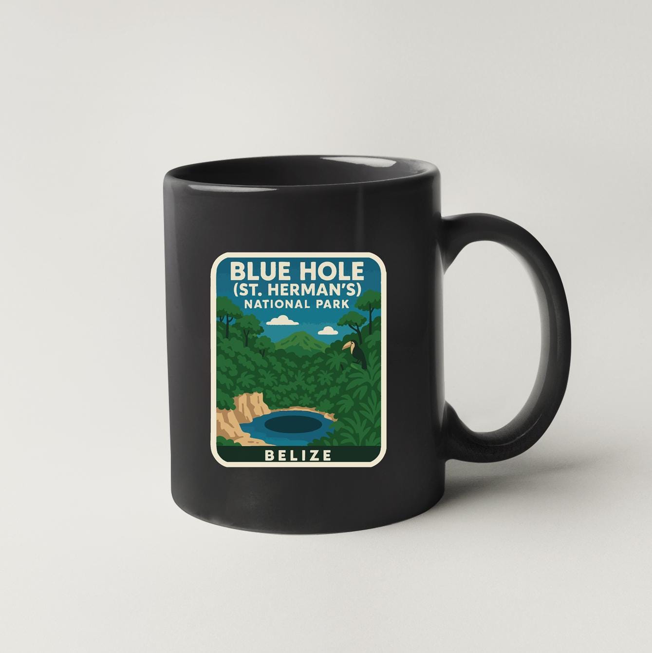 A black coffee mug with a graphic design depicting the Blue Hole, a natural wonder located in St. Herman's National Park in Belize.