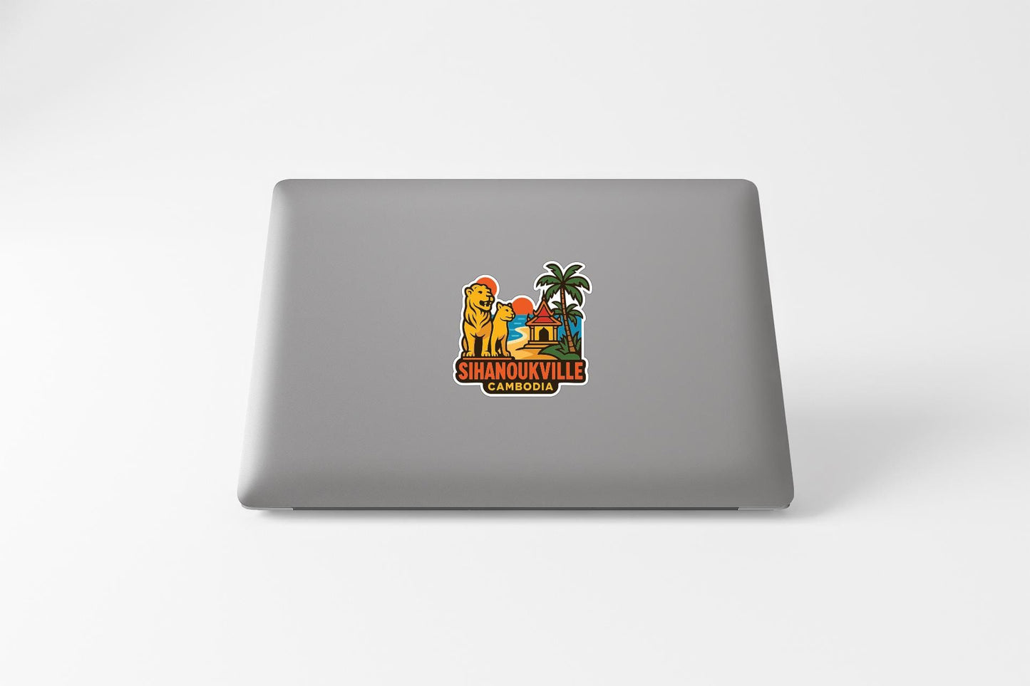 a sticker with a cartoon lion and palm tree, along with the text "SHANOUKVILLE CAMBODIA" printed on it.