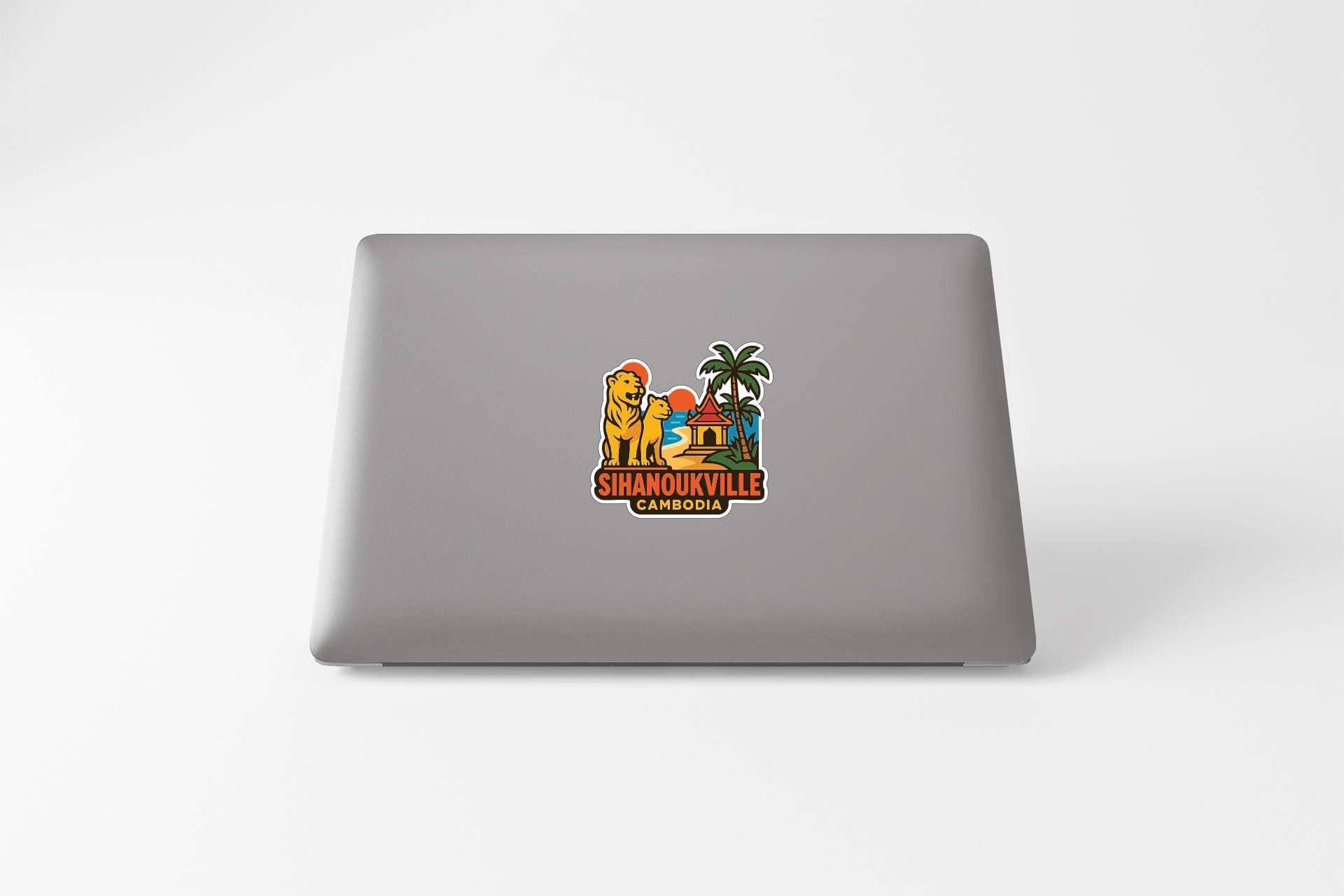 a sticker with a cartoon lion and palm tree, along with the text "SHANOUKVILLE CAMBODIA" printed on it.