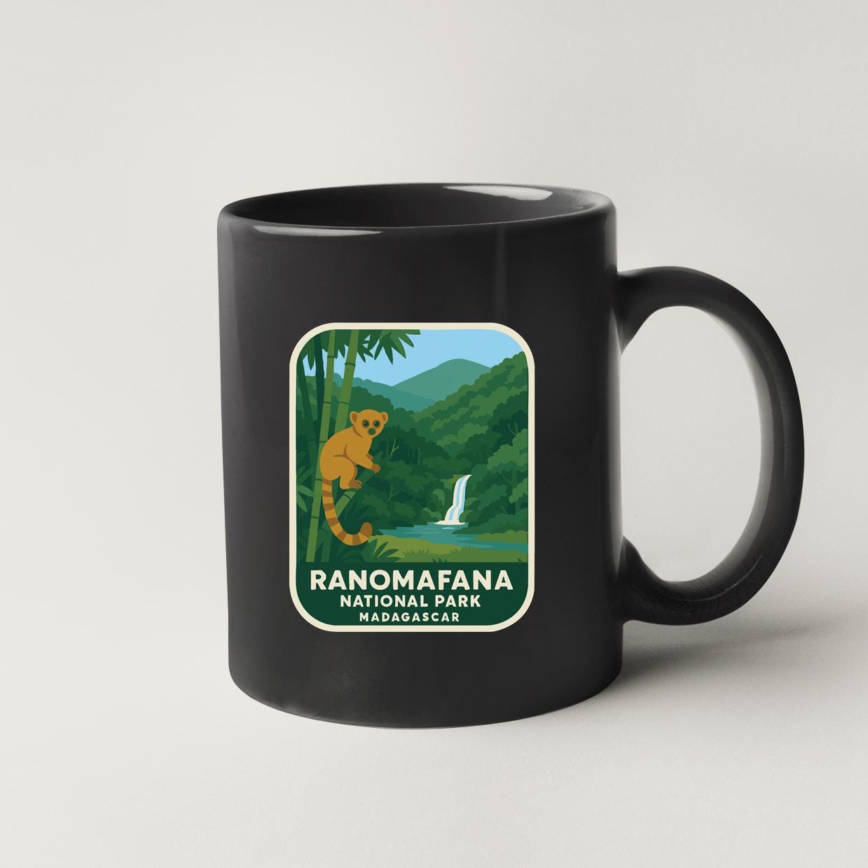 A black coffee mug with a label that says "RANOMAFANA NATIONAL PARK MADAGASCAR".