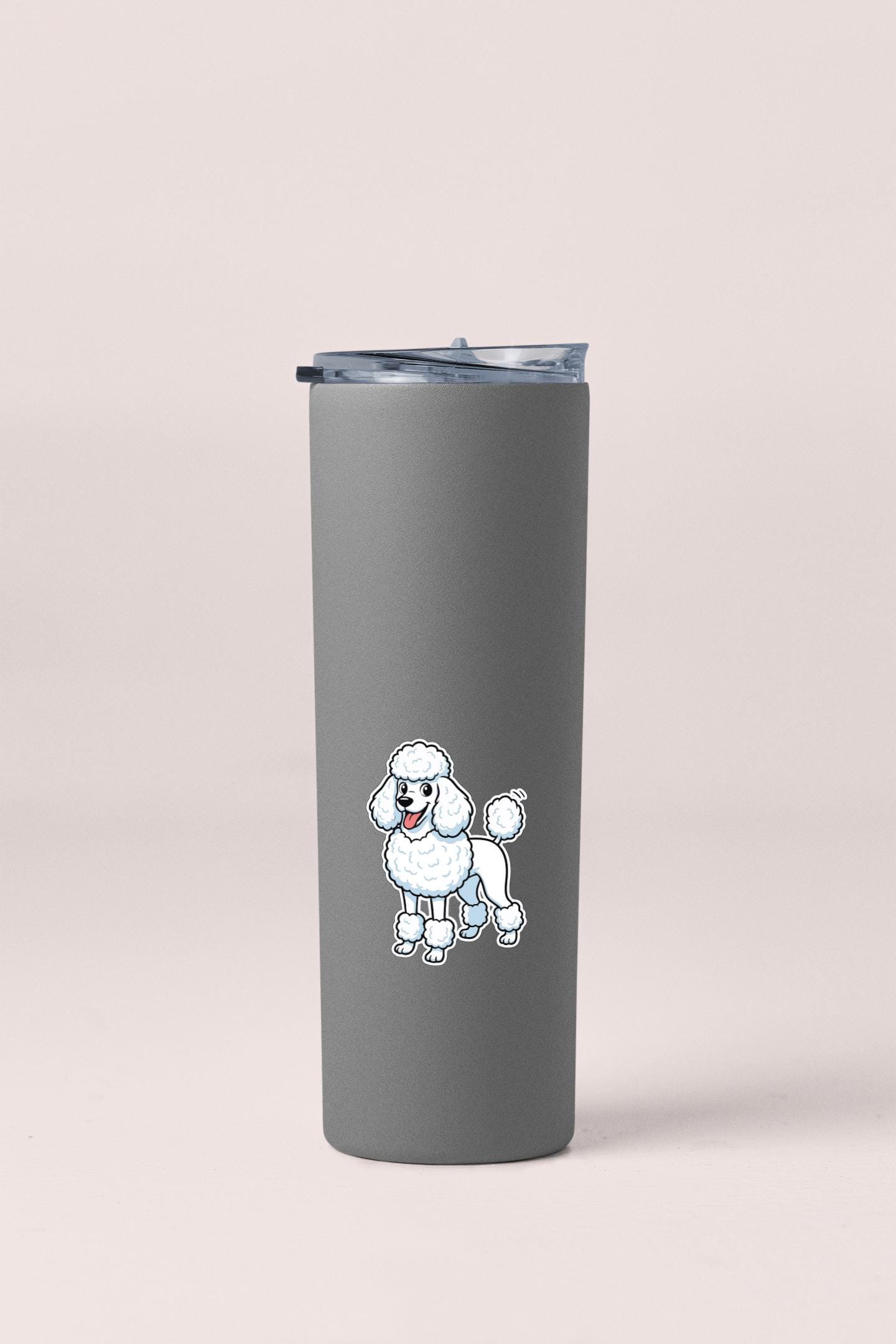 A gray insulated tumbler with a cartoon poodle sticker on it.