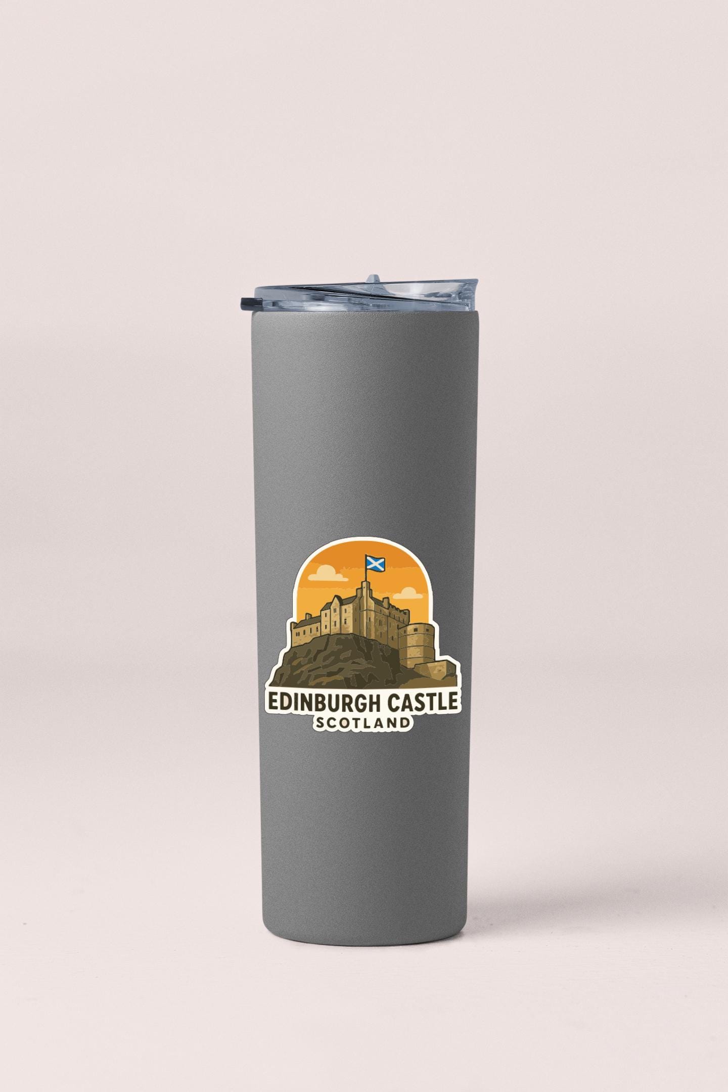 A gray tumbler with a sticker depicting Edinburgh Castle, Scotland.