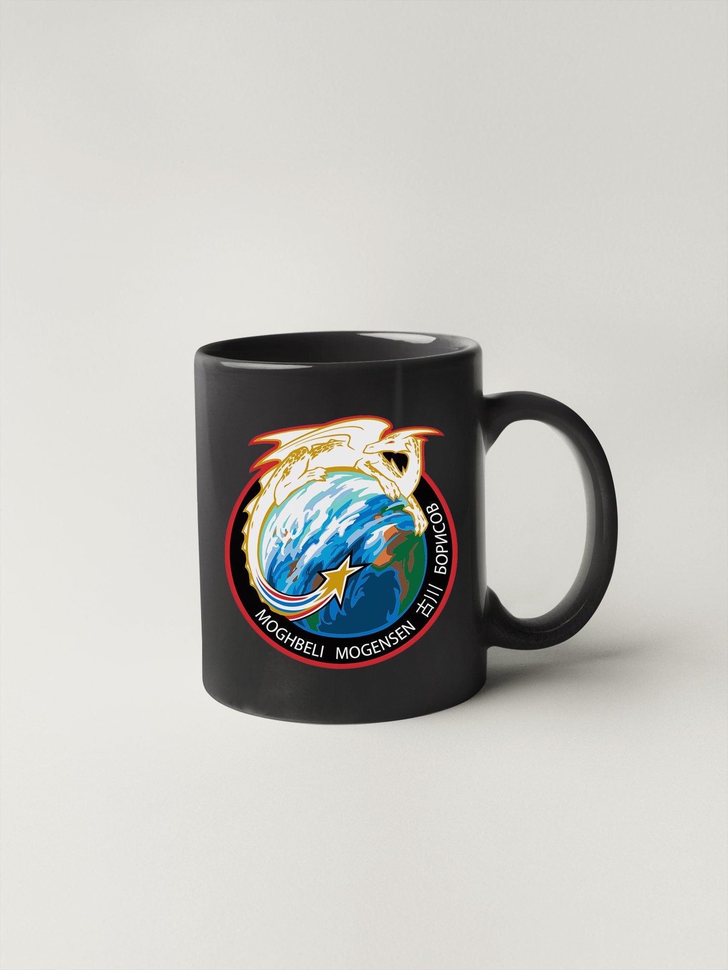 a black mug with a nasa emblem on it
