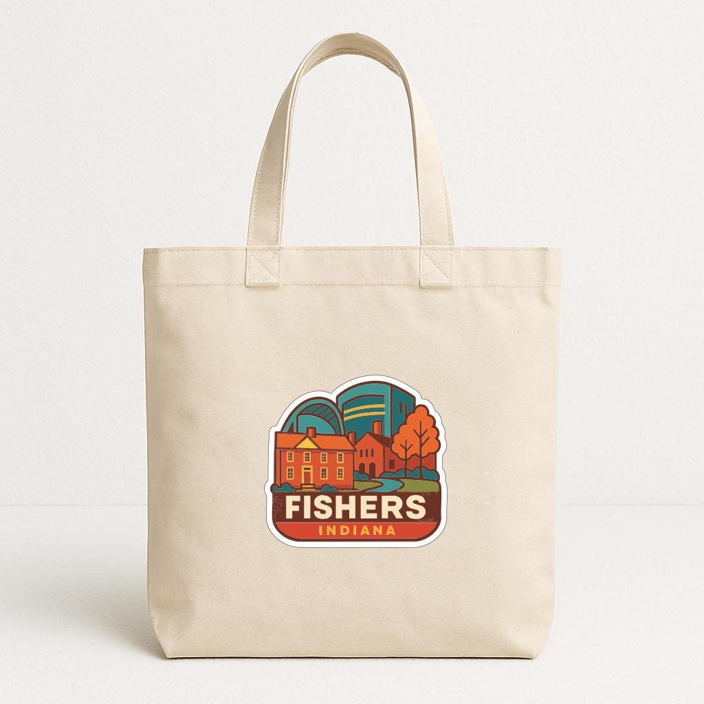 A beige tote bag with a graphic design featuring a cityscape and the text "FISHER'S INDIANA" printed on it.