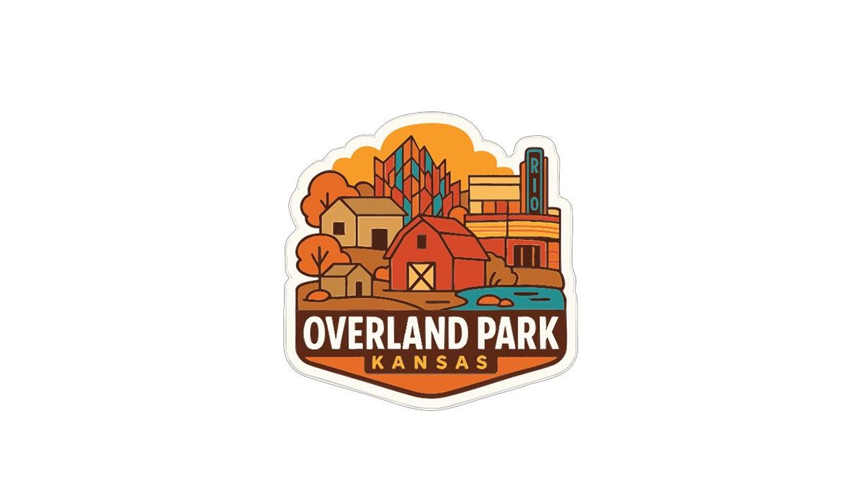 a colorful illustration of a town or city, with various buildings, trees, and a body of water. The text "OVERLAND PARK KANSAS" is prominently displayed in the center of the image.