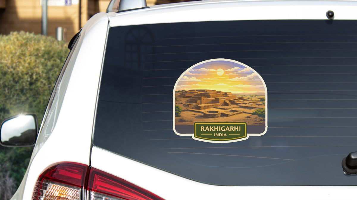 A sticker on the rear window of a car, depicting a desert landscape with a sunset in the background.