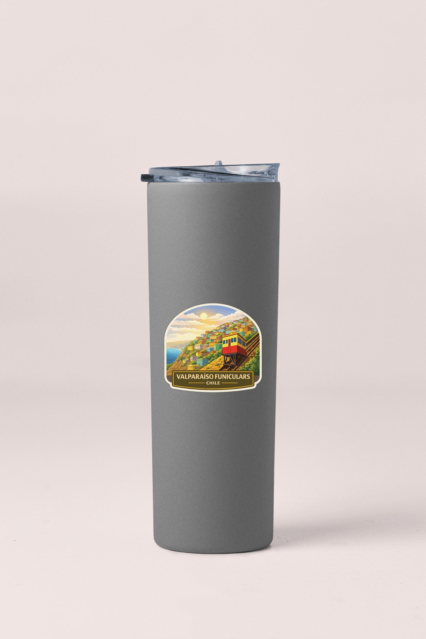 A gray insulated tumbler with a lid and a label featuring a scenic landscape.