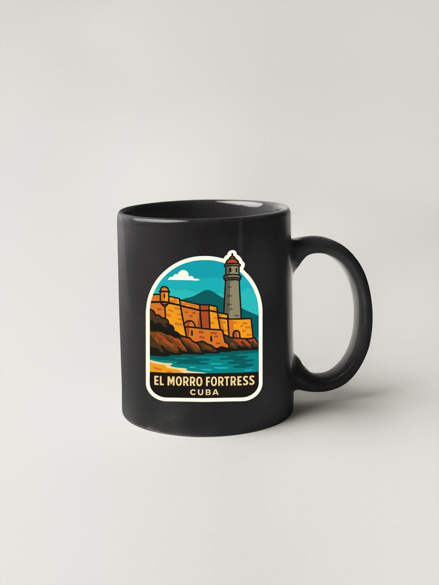 A black coffee mug with a colorful illustration of the El Morro Fortress in Cuba.