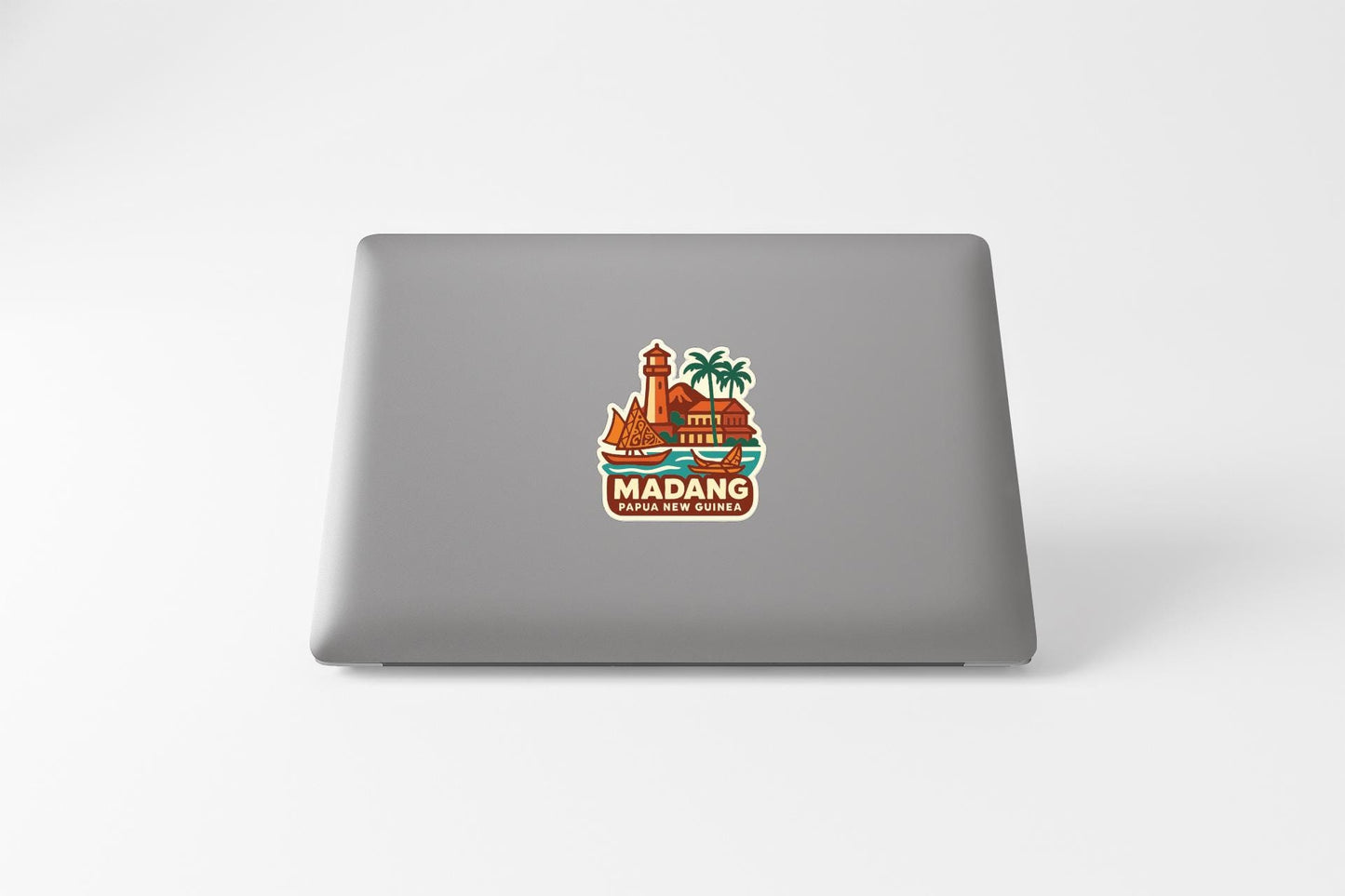 a sticker on the back of a laptop that says "Madang".