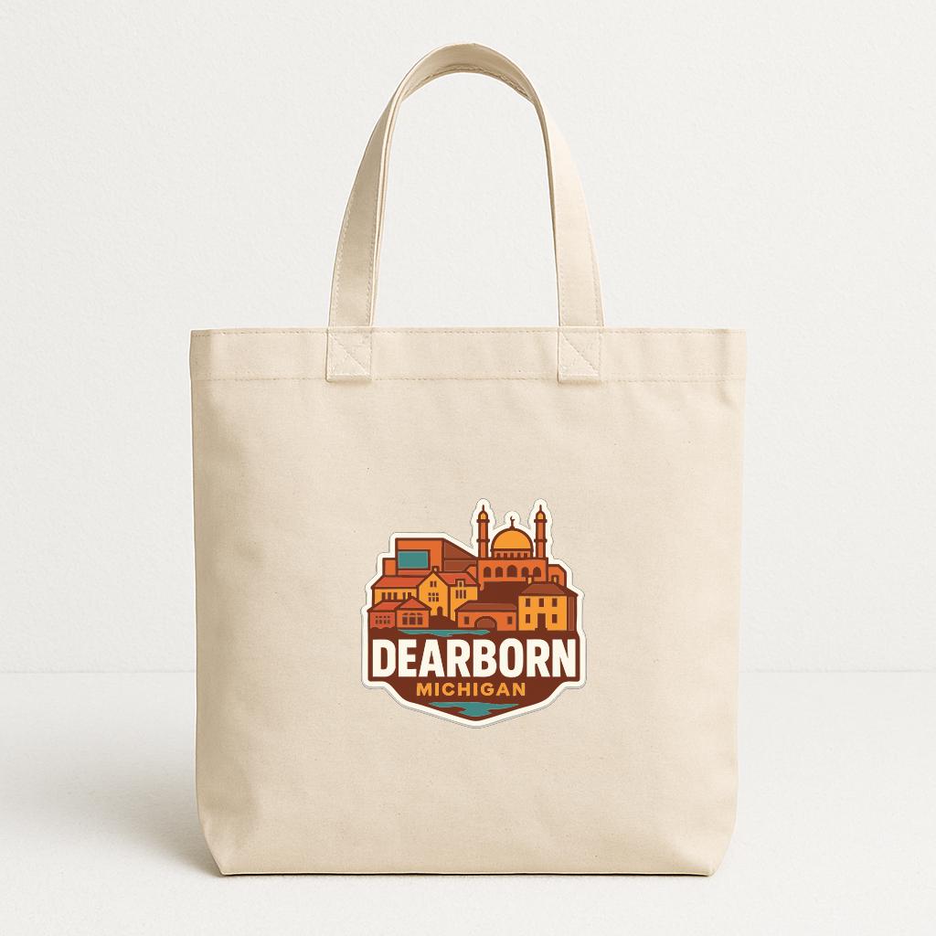 A beige tote bag with a graphic design featuring a city skyline and the text "DEARBORN MICHIGAN".