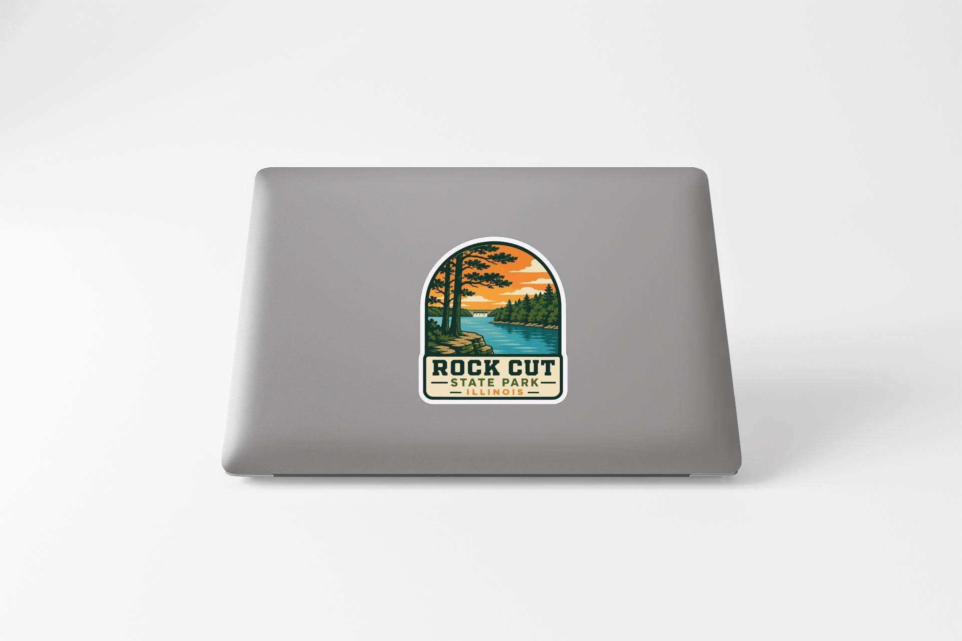 a sticker with a scenic landscape of a lake and trees, along with the text "ROCK CUT STATE PARK".