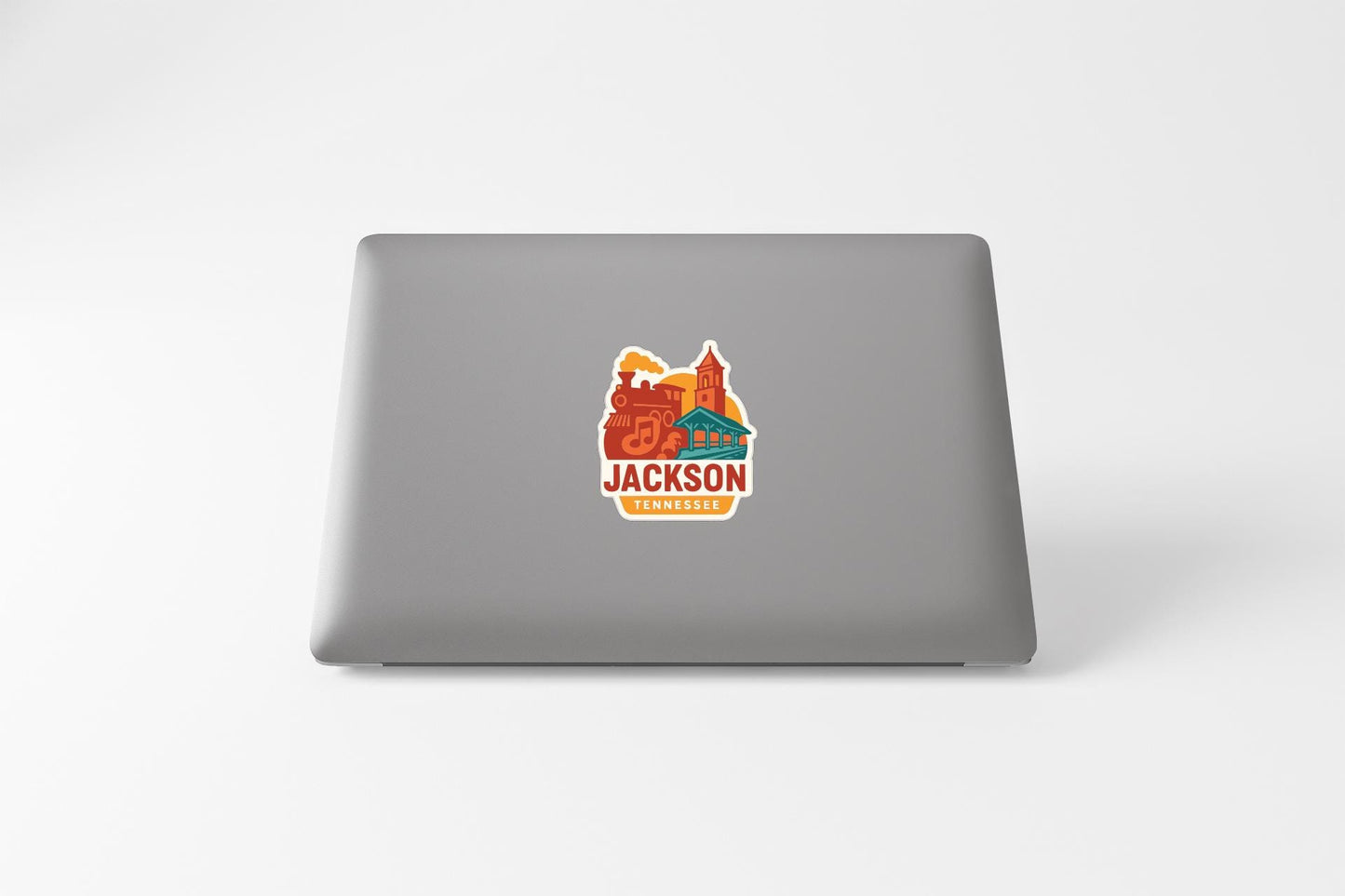 A sticker on the back of a laptop displaying the text "JACKSON TENNESSEE" along with an illustration of a cityscape.