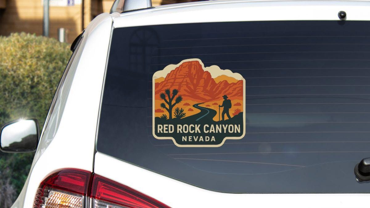 a sticker on the rear window of a vehicle that says "Red Rock Canyon Nevada".