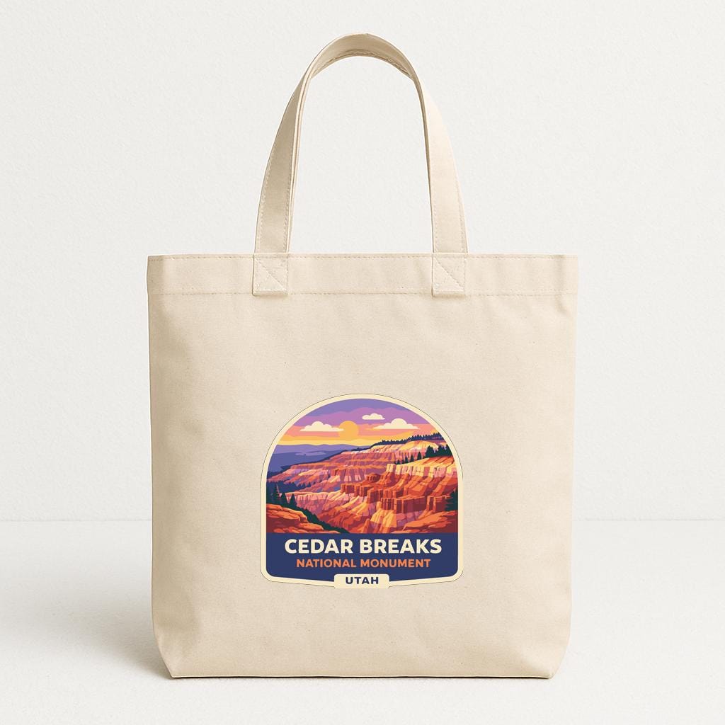 A beige tote bag with a graphic design depicting the scenic landscape of the Cedar Breaks National Monument in Utah.