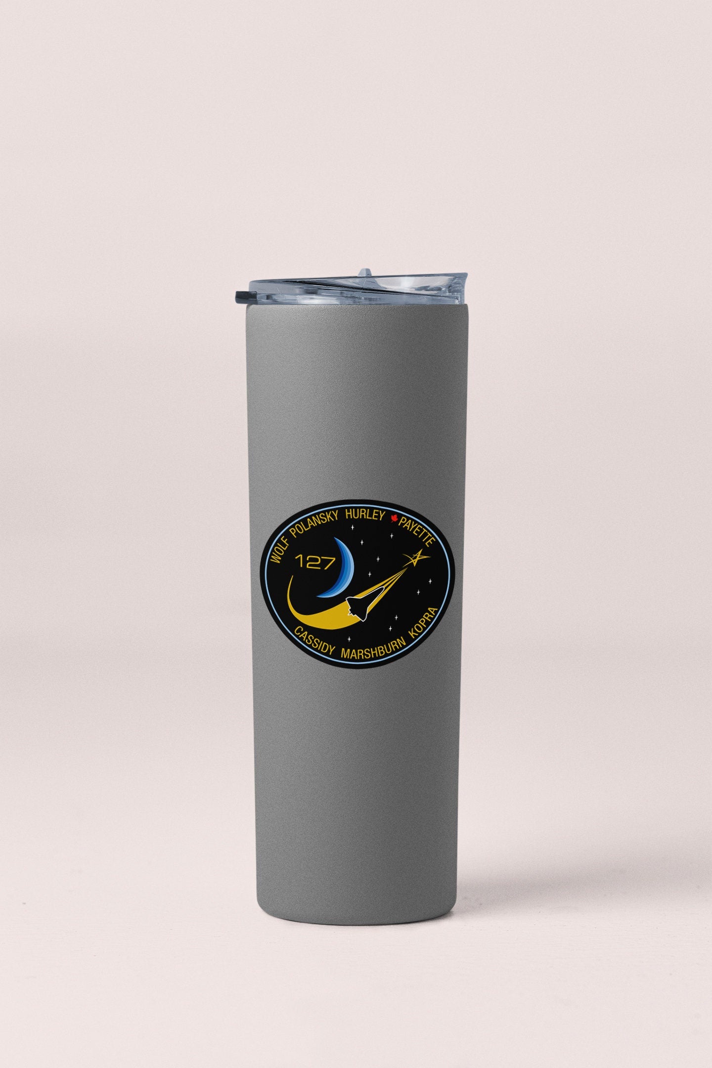 a stainless steel tumbler with a nasa emblem on it