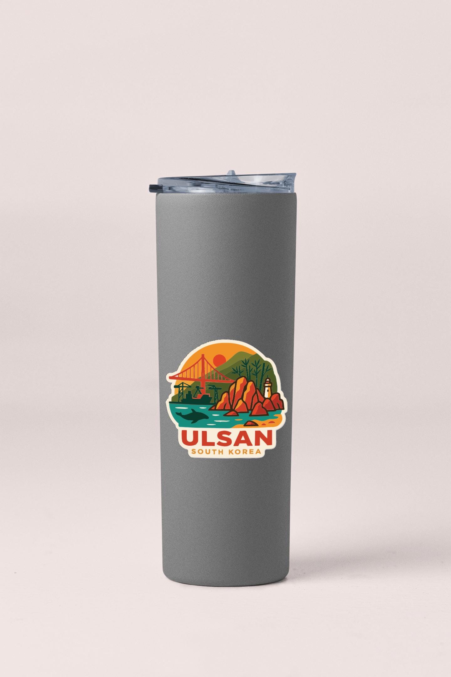 A gray insulated tumbler with a sticker depicting a scenic landscape and the text "Ulsan South Korea".