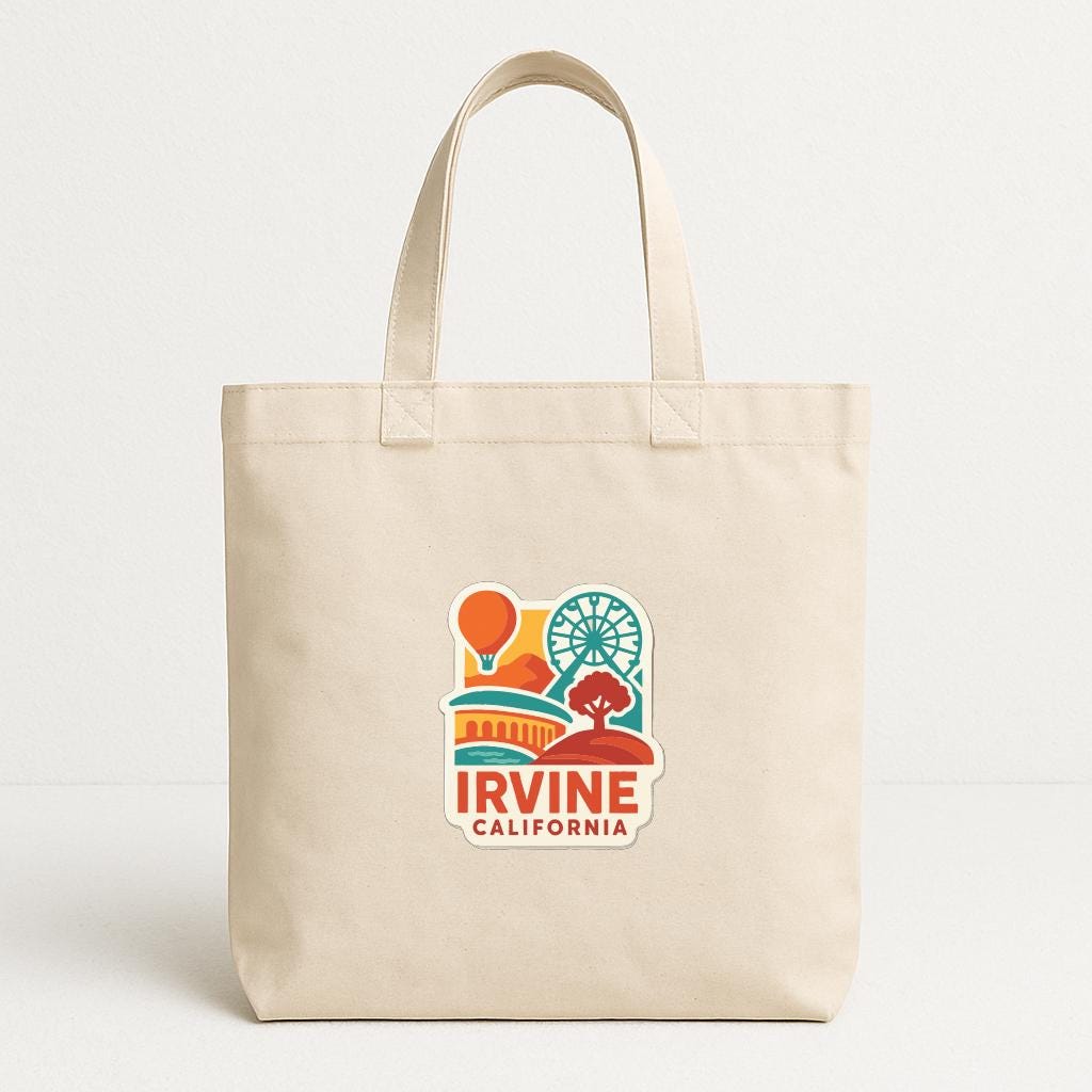A beige tote bag with a colorful graphic of a cityscape and the text "Irvine, California" printed on it.