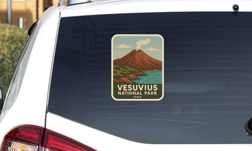 A sticker on the rear window of a car that says "Vesuvius National Park Italy".