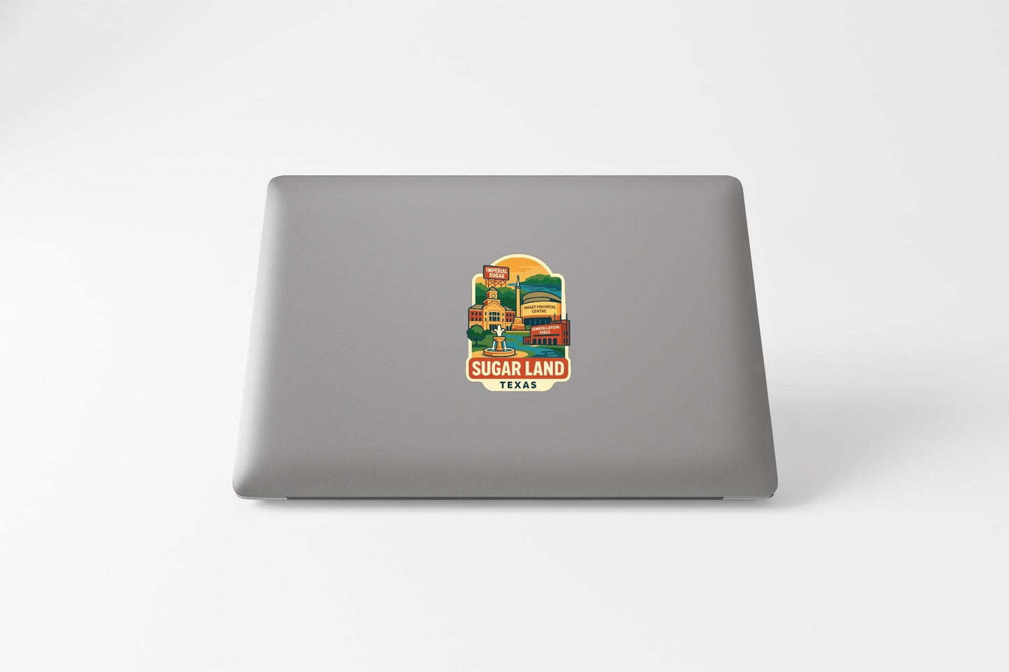 a sticker or decal of Sugar Land, Texas, on the back of a laptop computer.