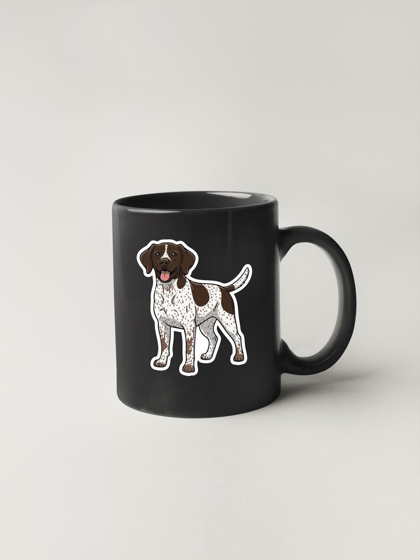 A black mug with a cartoon illustration of a dog on it.