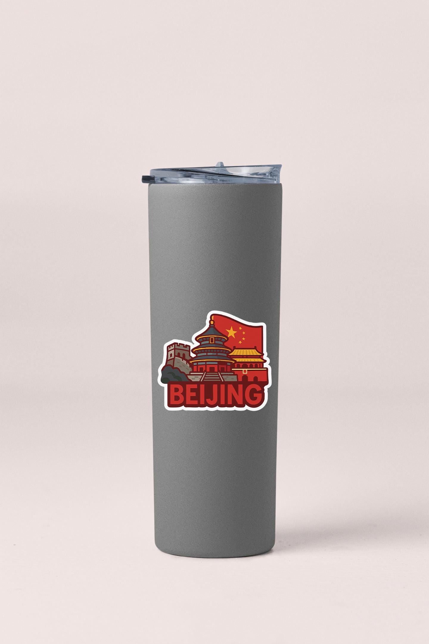 a stainless steel tumbler with a red and yellow sticker on it