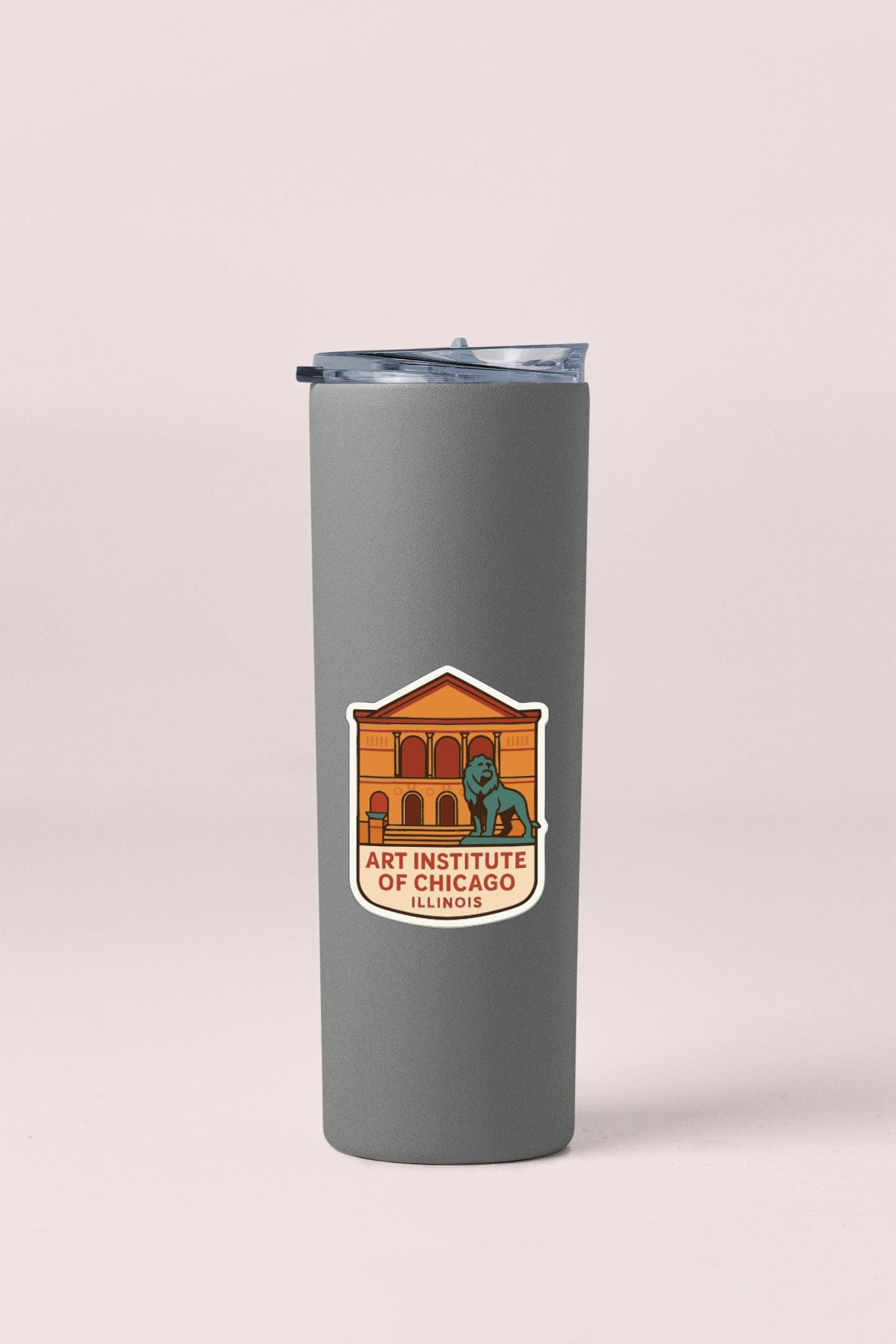 A gray insulated tumbler with a sticker featuring the logo of the Art Institute of Chicago in Illinois.