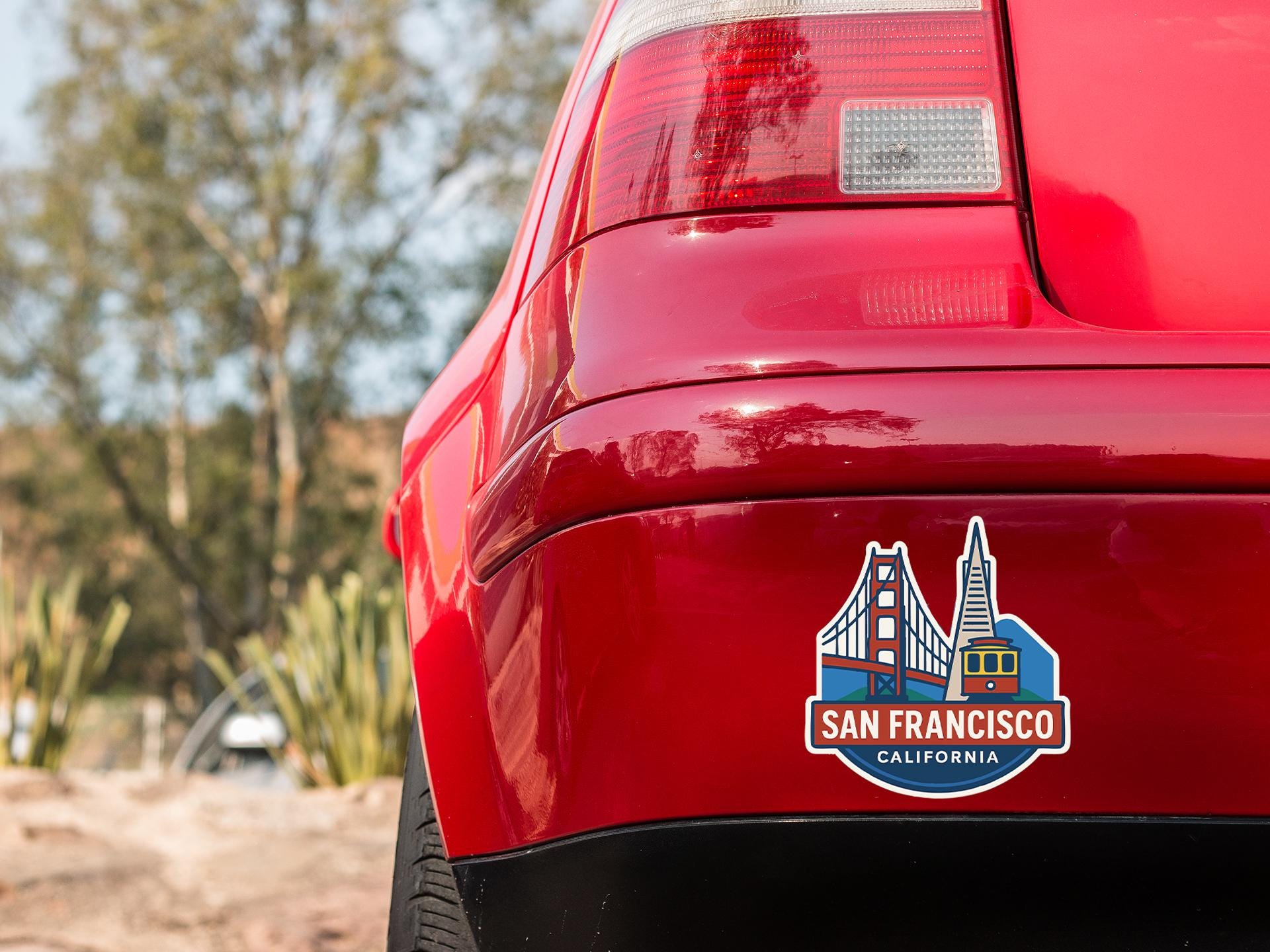 a red car with a san francisco sticker on it
