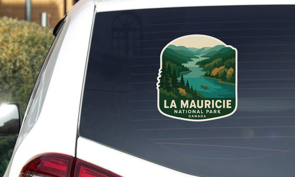 A sticker on the rear window of a vehicle that says "LA MAURICIE NATIONAL PARK CANADA".