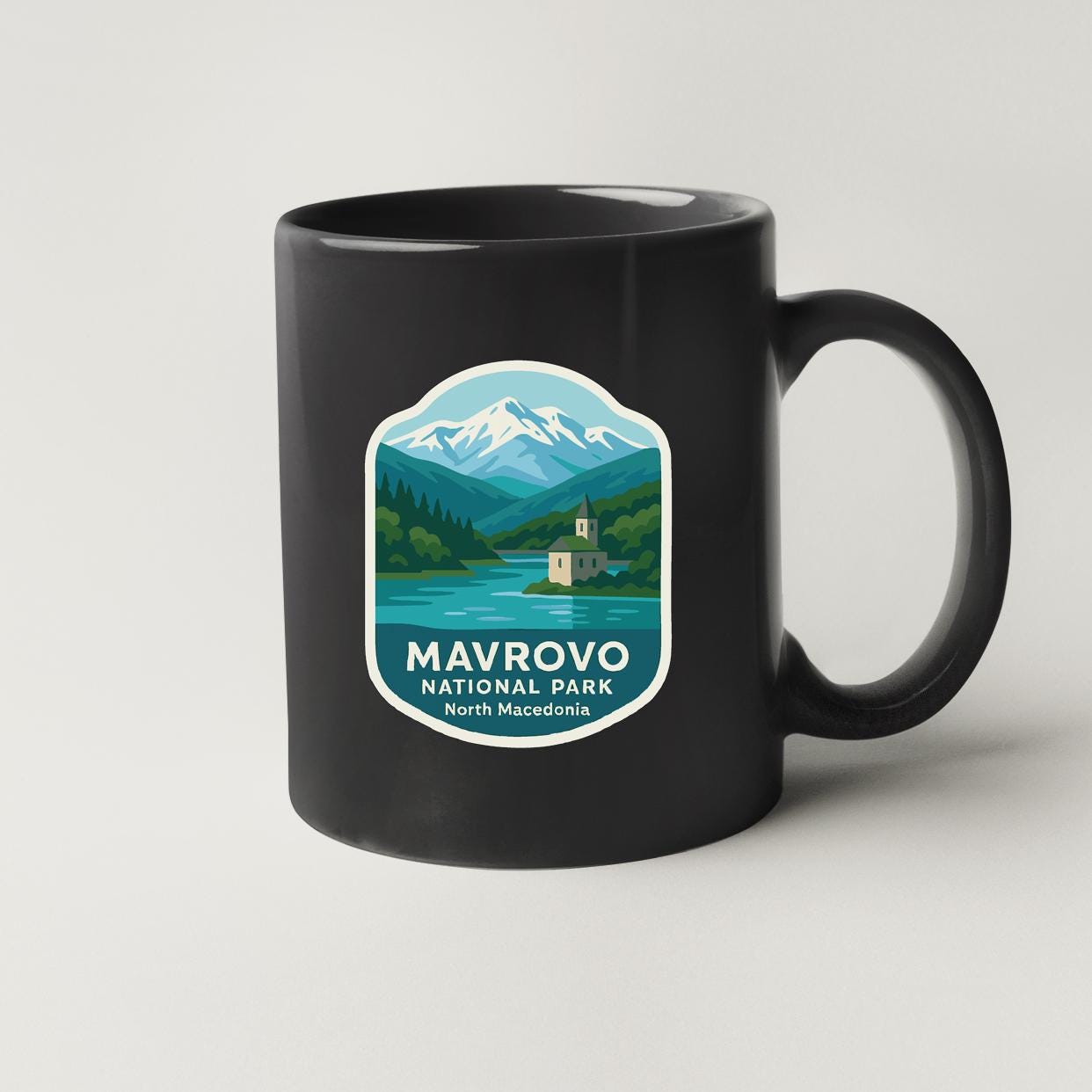 A black coffee mug with a label that says "MAYROVO NATIONAL PARK North Macedonia".