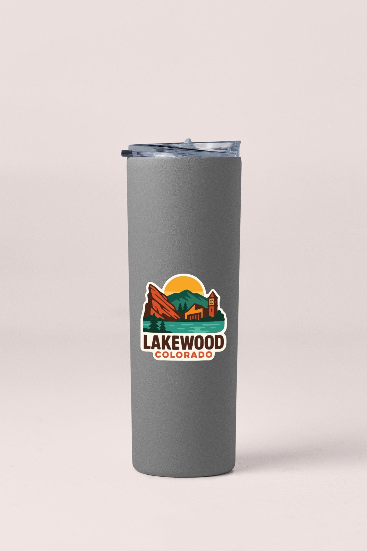 A gray insulated tumbler with a printed logo that says "LAKEWOOD COLORADO".