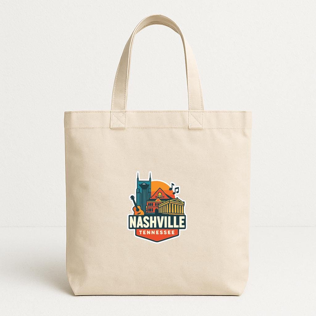 A beige tote bag with a colorful graphic of Nashville, Tennessee, and the text "NASHVILLE TENNESSEE" printed on it.