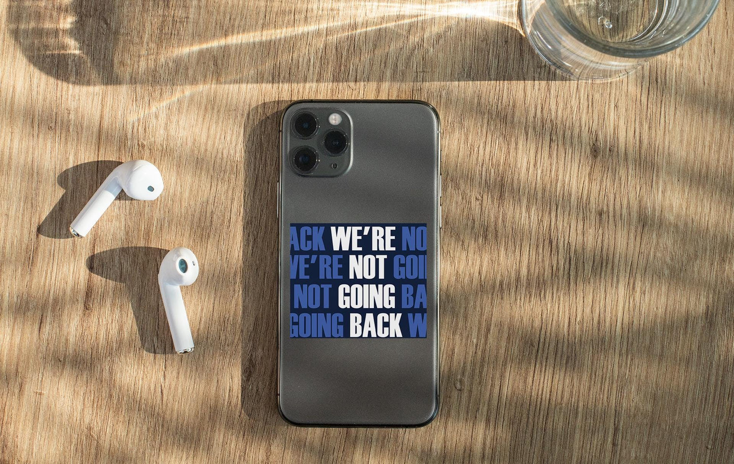 a cell phone sitting on top of a wooden table