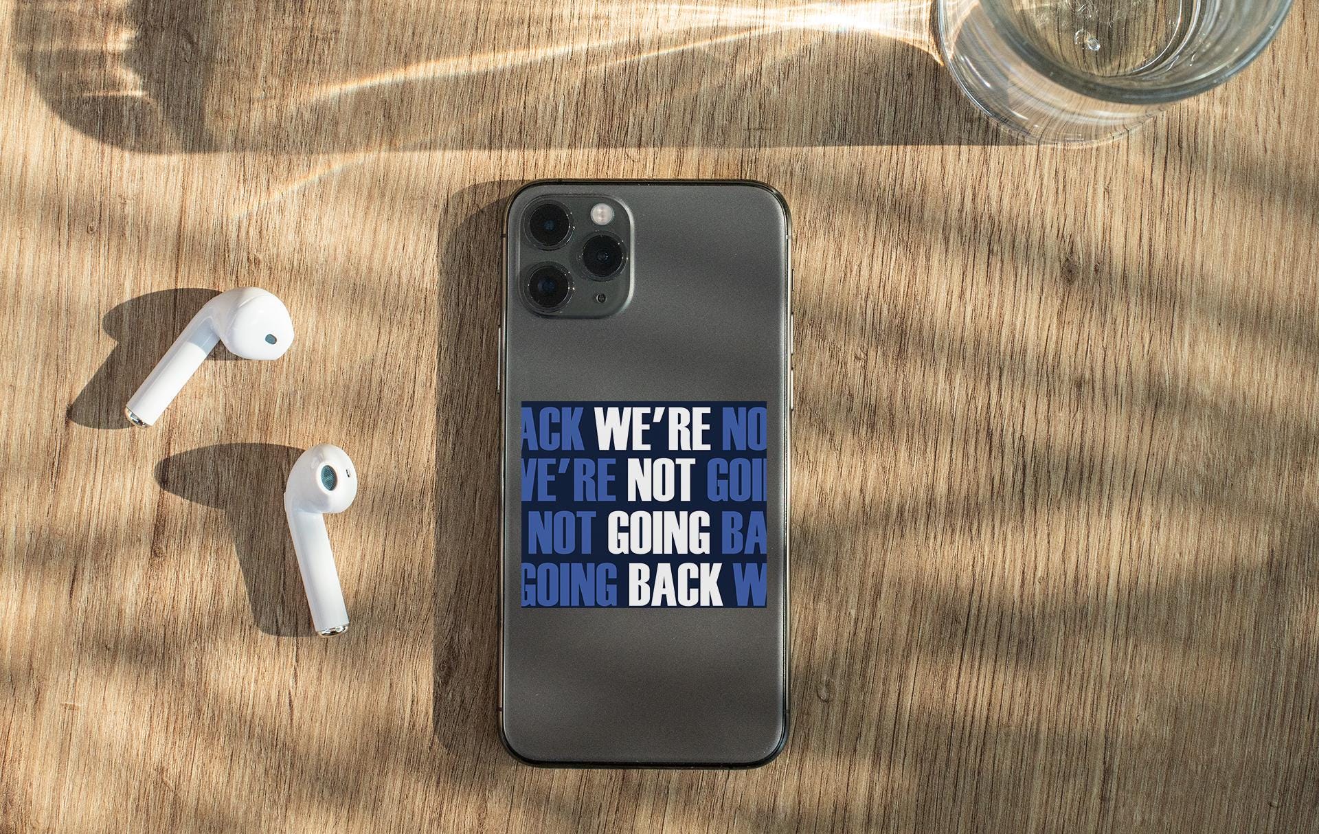 a cell phone sitting on top of a wooden table
