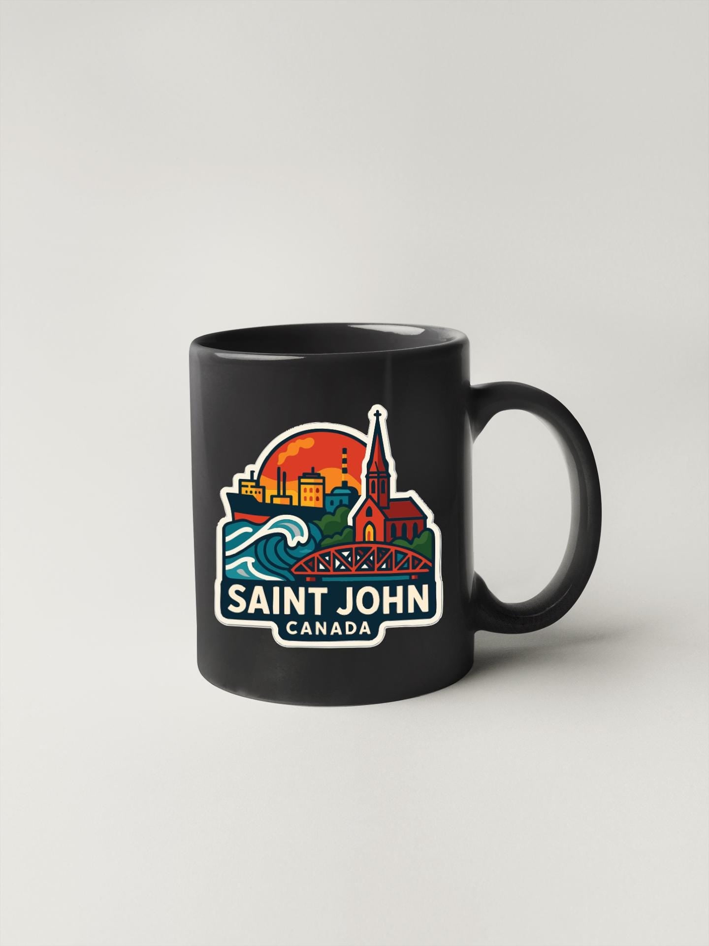 A black coffee mug with a colorful graphic design depicting the Saint John, Canada skyline.