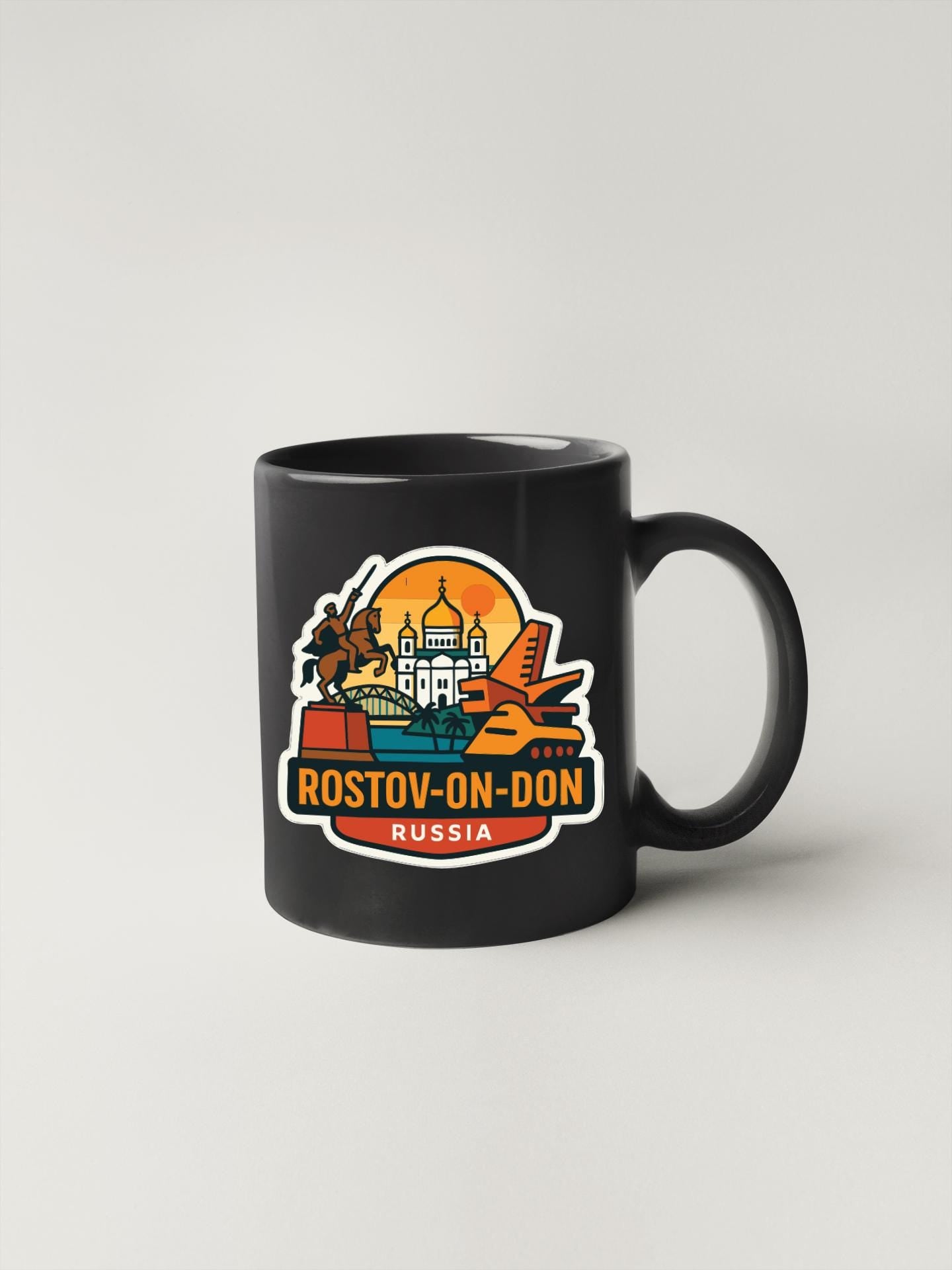 A black coffee mug with a colorful graphic design featuring a city skyline and the text "ROSTOV-ON-DON RUSSIA".