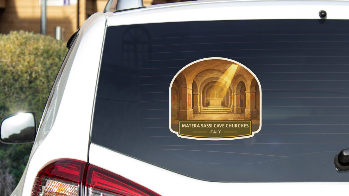 a sticker on the rear window of a white car, depicting a hallway with arches and a cross at the end.