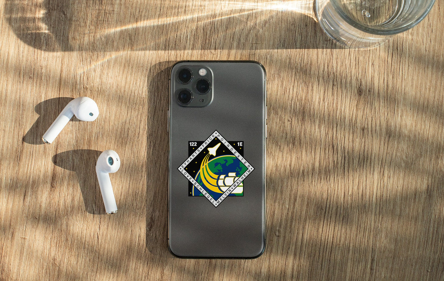 a phone and ear buds sitting on a table
