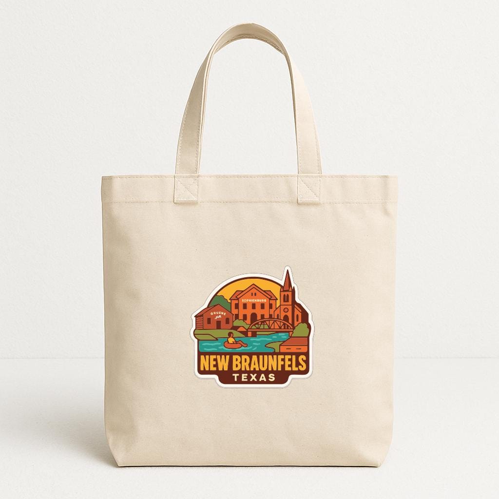 A beige tote bag with a printed design depicting a landmark in New Braunfels, Texas.