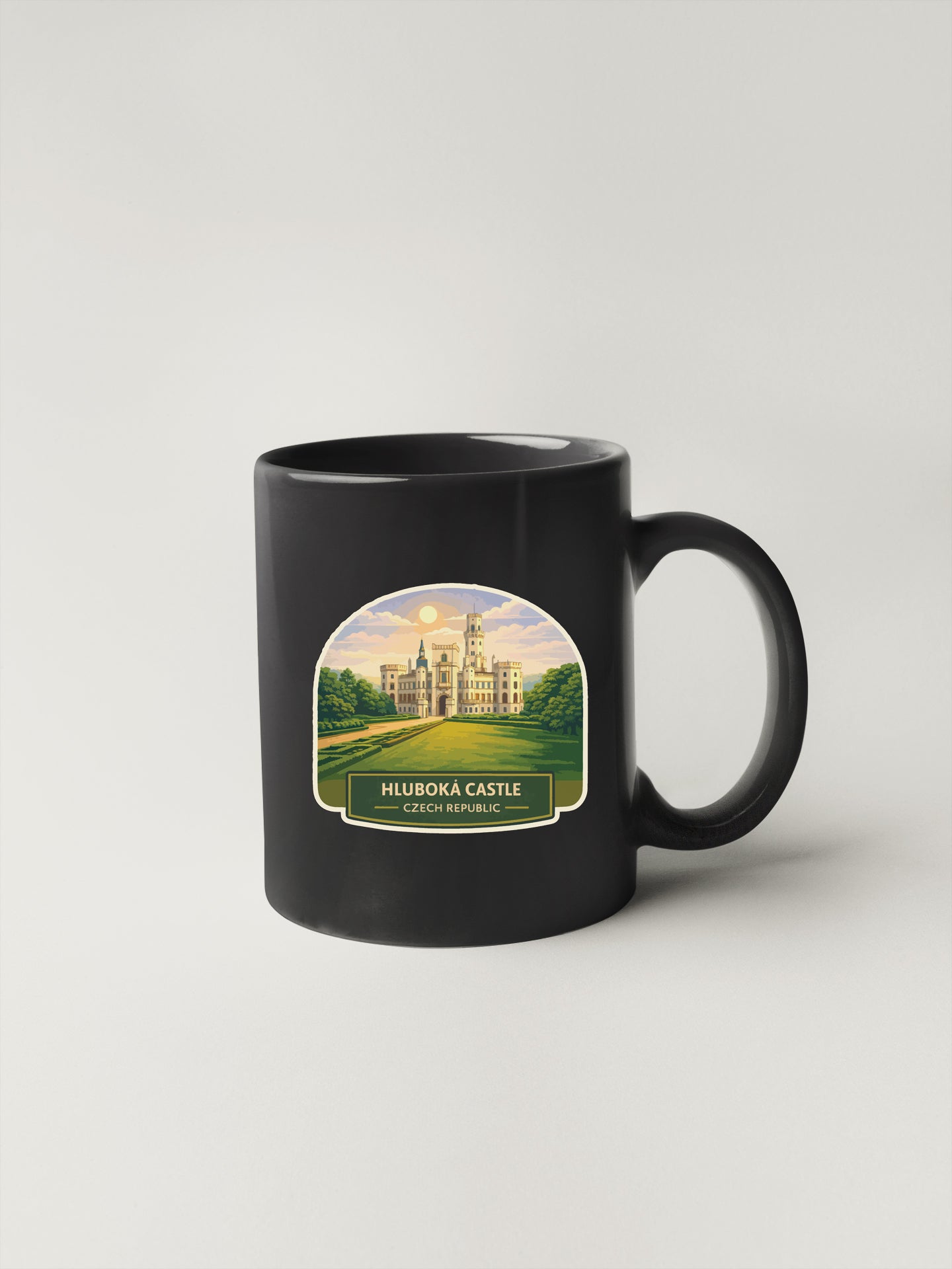 A black coffee mug with a label depicting the HLBOKA CASTLE in the Czech Republic.