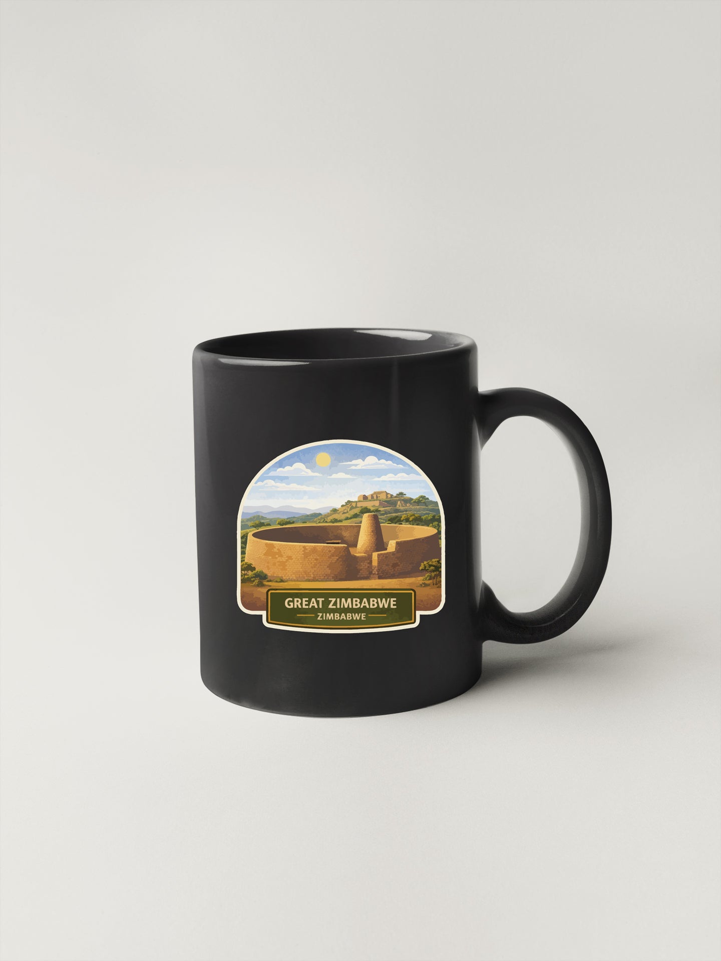 A black coffee mug with a label depicting the Great Zimbabwe, a UNESCO World Heritage Site in Zimbabwe.