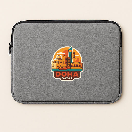 a gray laptop sleeve with a sticker of the city of Doha, Qatar.