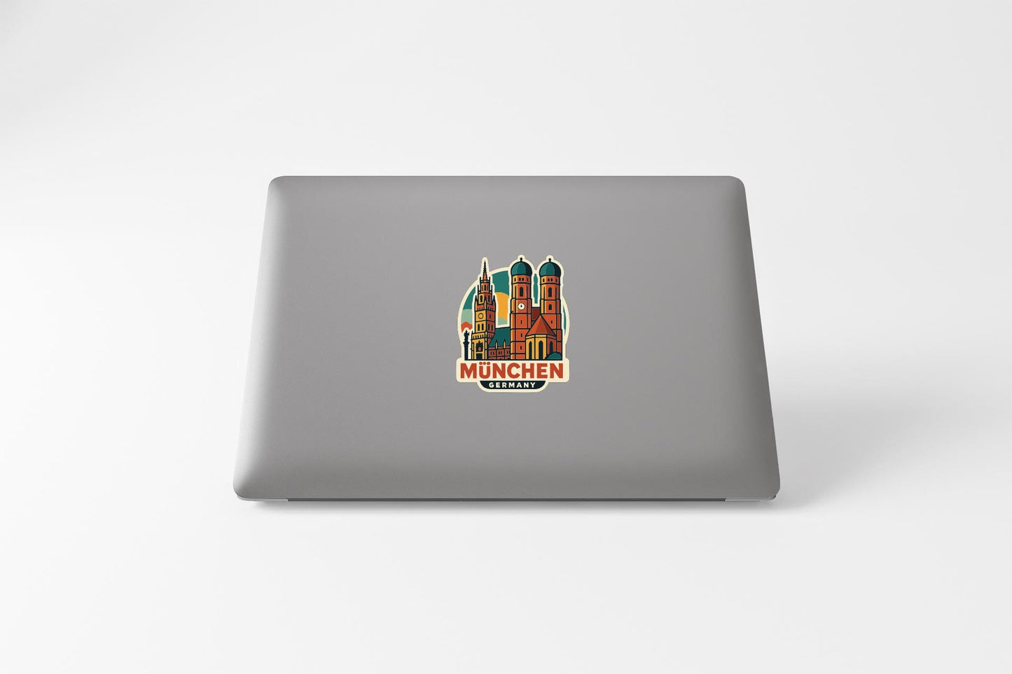 a sticker of the Munich Cathedral on the back of a laptop.