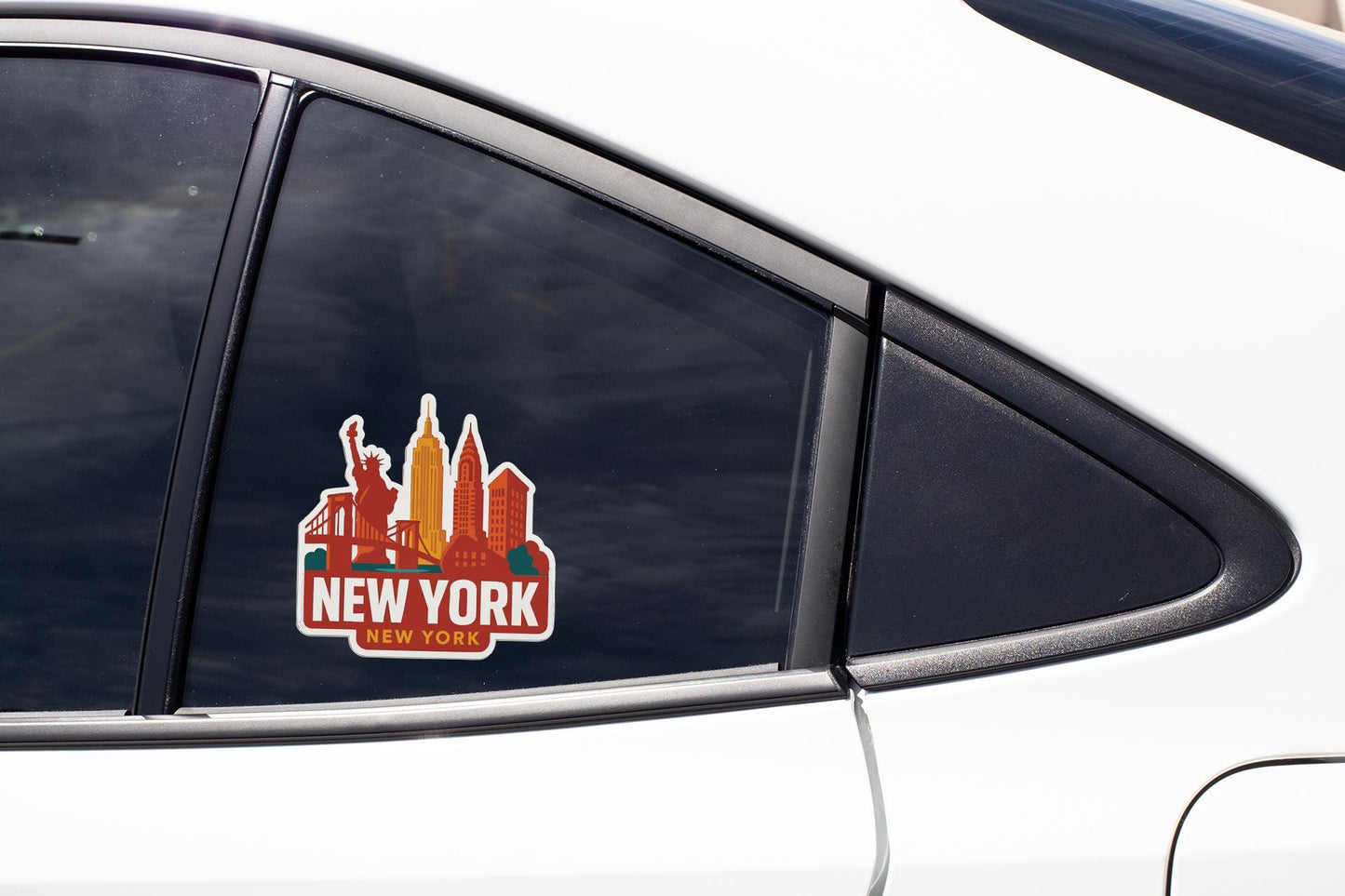 A sticker on the side of a car window that says "NEW YORK" with a silhouette of the Statue of Liberty in the background.
