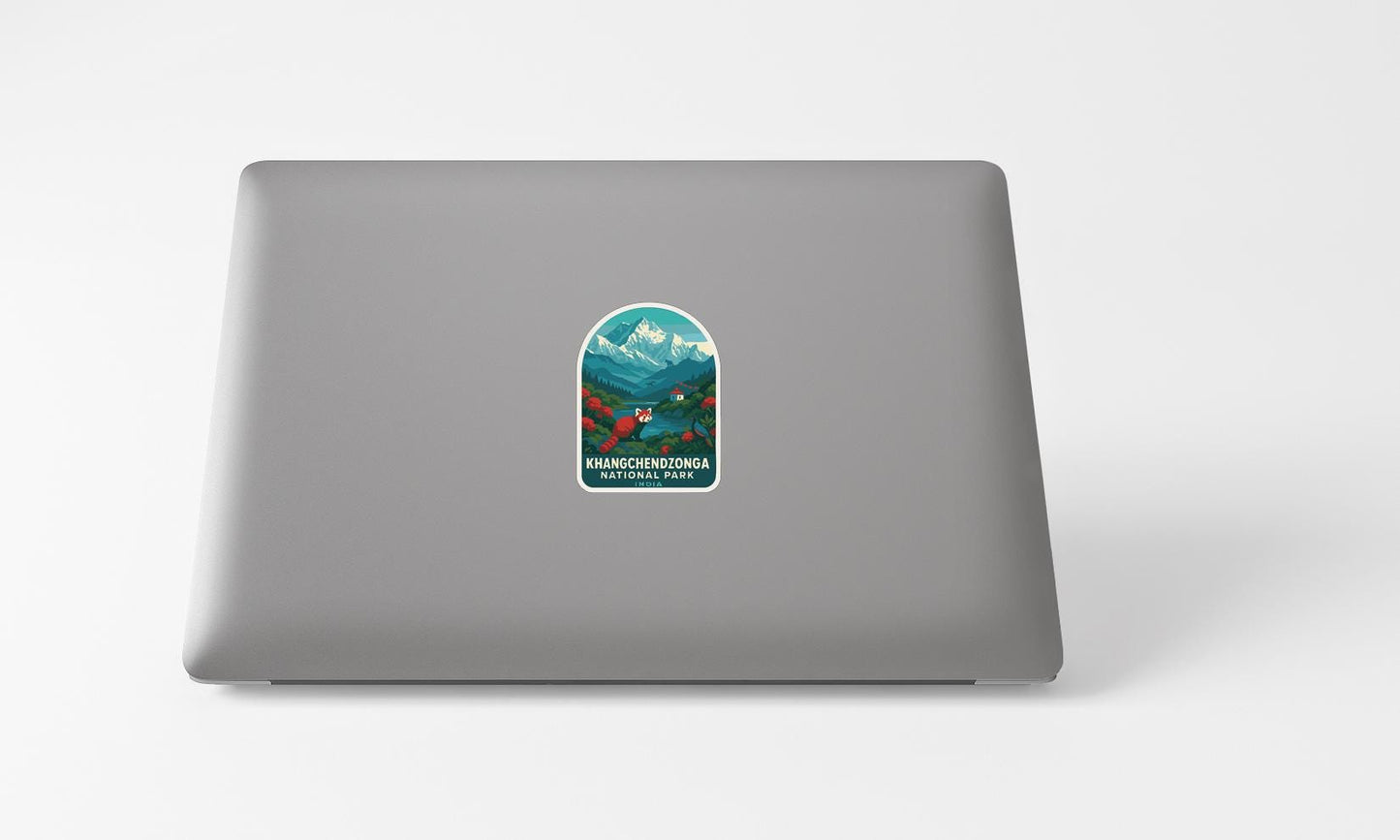 A sticker with a mountain landscape and text on the back of a laptop computer.