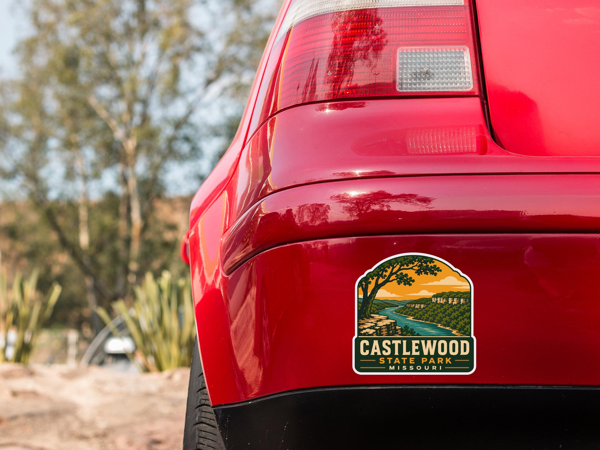 the rear end of a red car with a sticker on the back window that says "CASTLEWOOD STATE PARK MISSOURI".