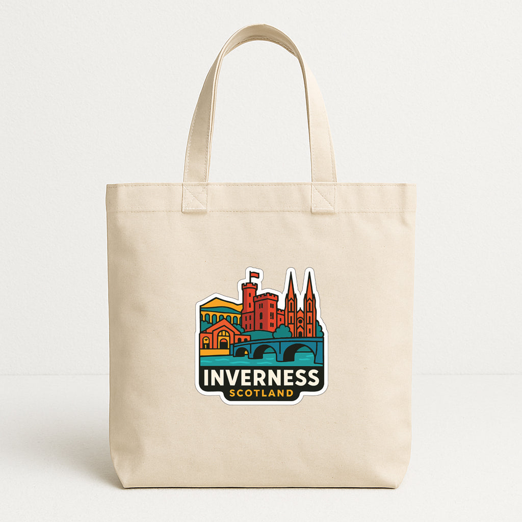 A beige tote bag with a colorful graphic depicting the Inverness, Scotland, featuring a castle, bridge, and other landmarks.
