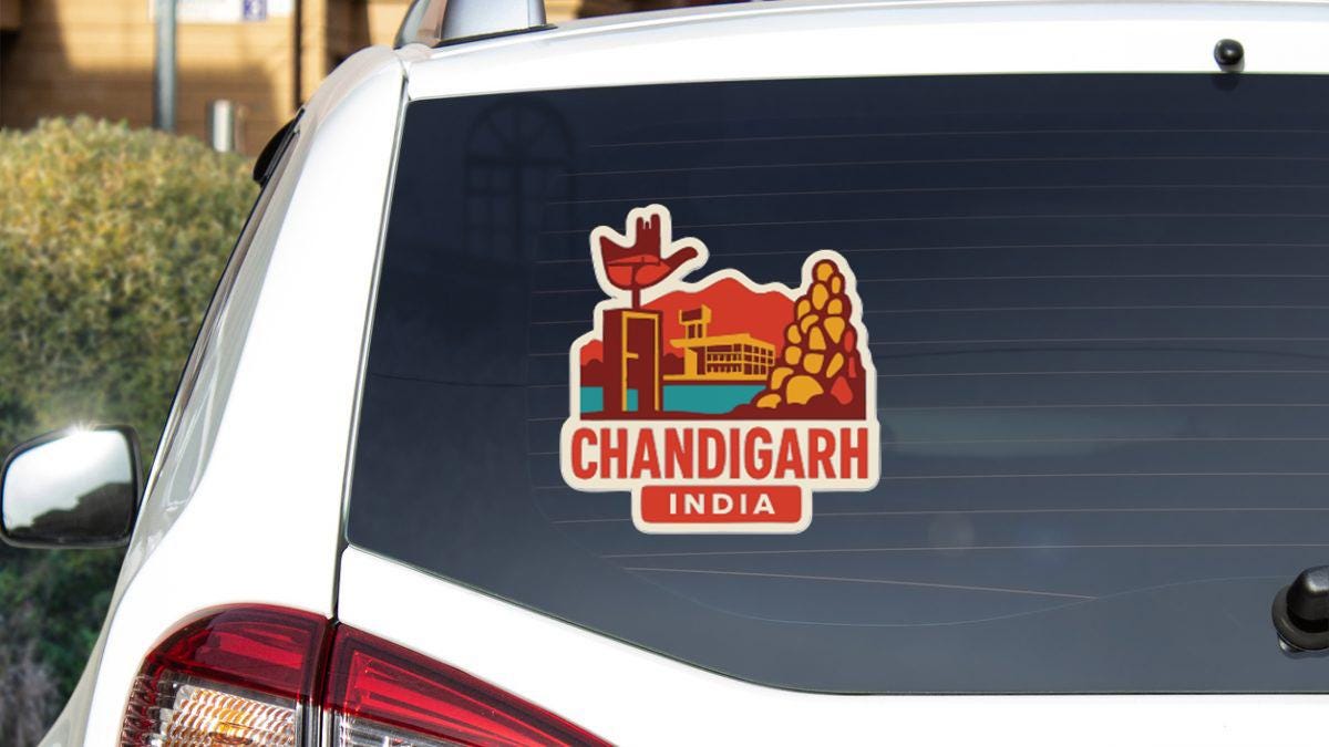 a sticker on the rear window of a car that says "CHANDIGARh INDIA".