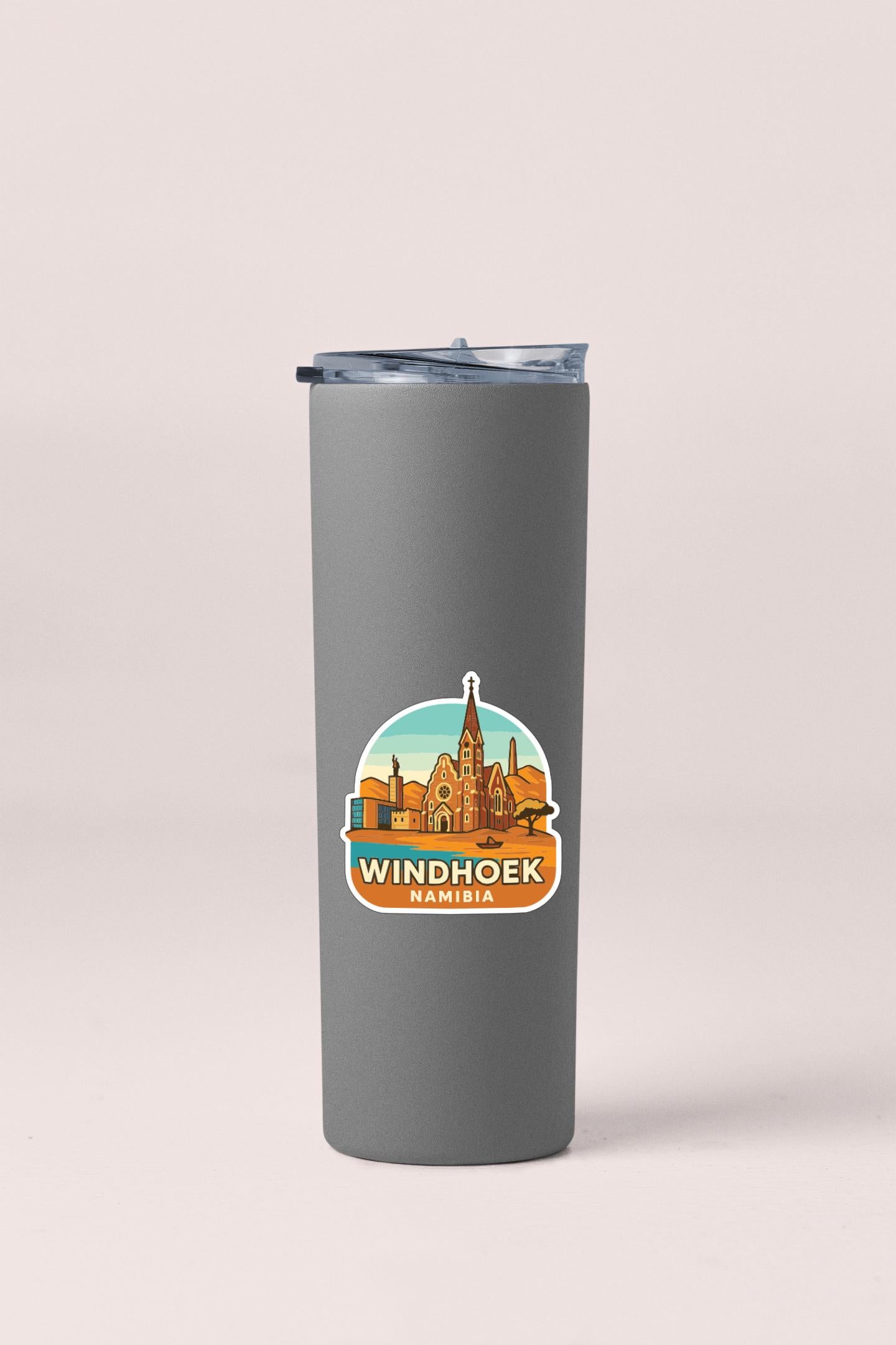 A gray insulated tumbler with a sticker depicting the Windhoek cityscape.
