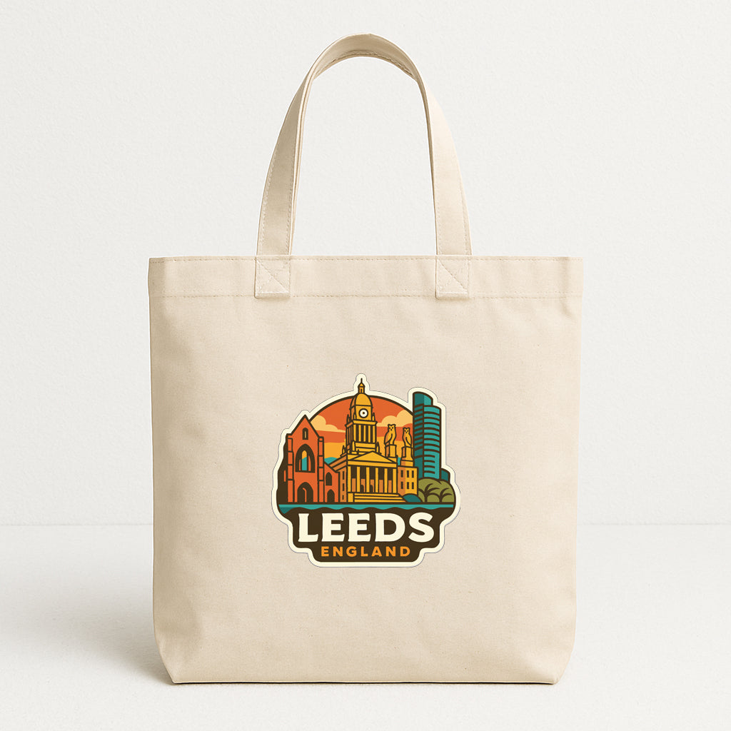 A beige tote bag with a printed design of the city of Leeds, England, featuring landmarks and buildings.