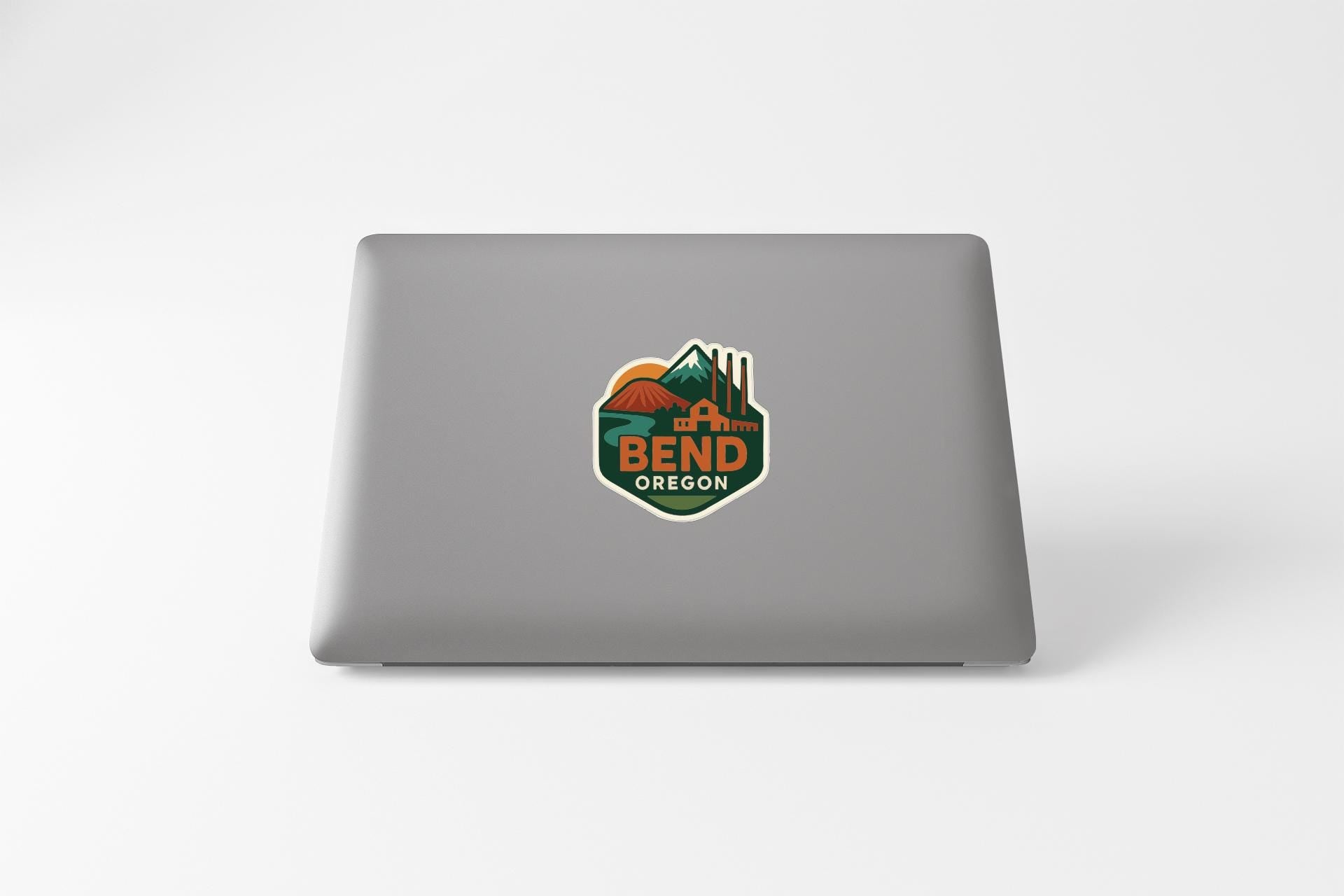 a laptop with a sticker on the back cover that says "BEND OREGON".